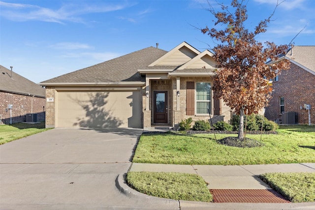 view of front of property with a garage, a front yard, and central air condition unit