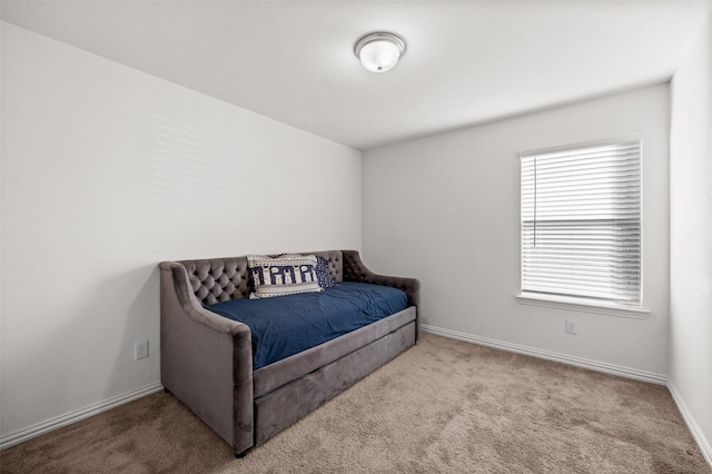 bedroom featuring light colored carpet