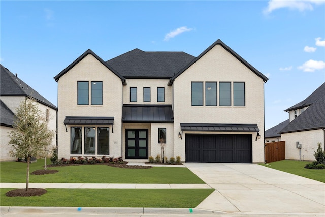 view of front of property featuring a garage and a front lawn