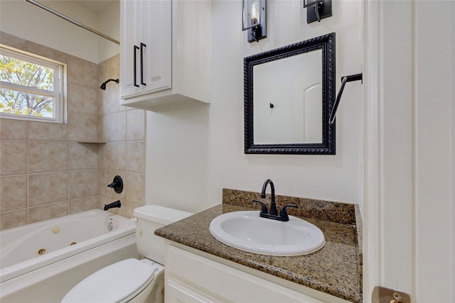 full bathroom featuring vanity, toilet, and tiled shower / bath