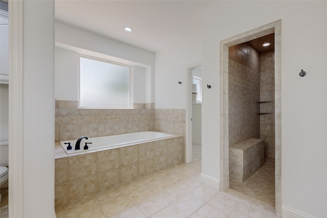 bathroom with tile patterned flooring, plus walk in shower, and toilet