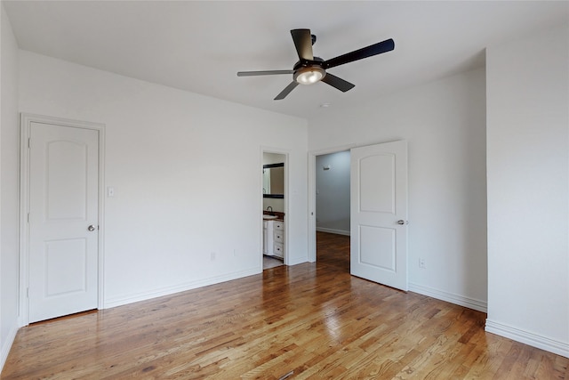 spare room with ceiling fan and light wood-type flooring