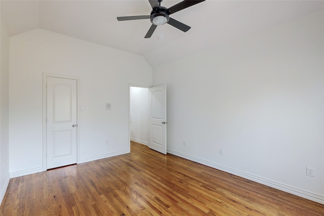 unfurnished bedroom featuring hardwood / wood-style flooring, vaulted ceiling, and ceiling fan