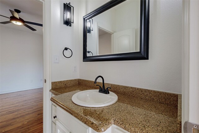 bathroom featuring ceiling fan, vanity, and hardwood / wood-style floors