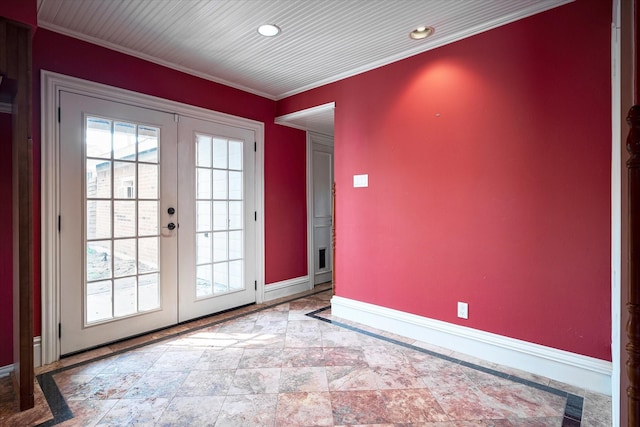 entryway with crown molding and french doors