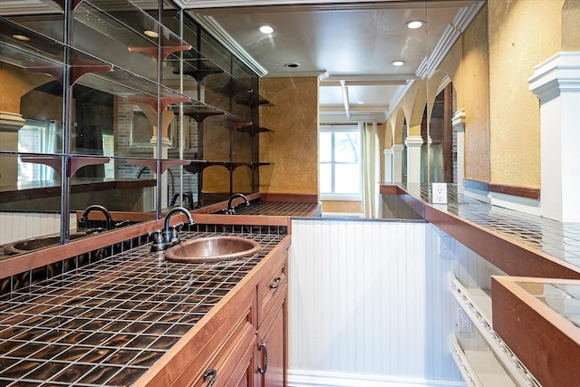 kitchen featuring crown molding and sink