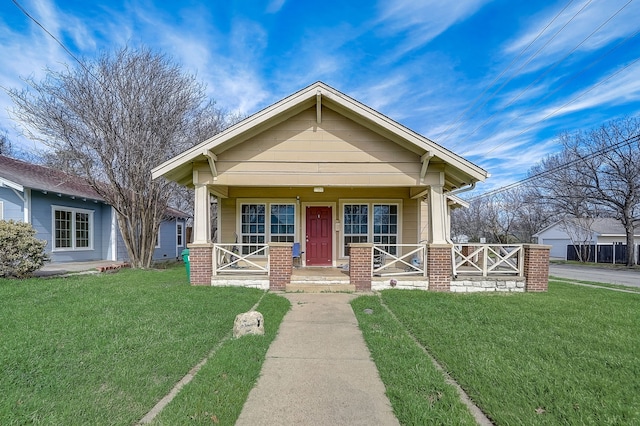 bungalow-style house with covered porch and a front yard