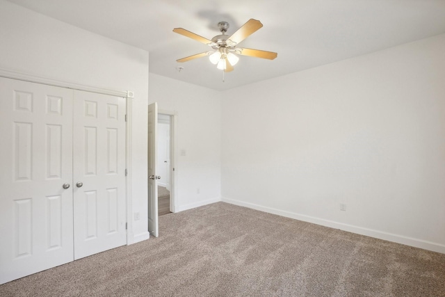 unfurnished bedroom featuring a closet, ceiling fan, and carpet