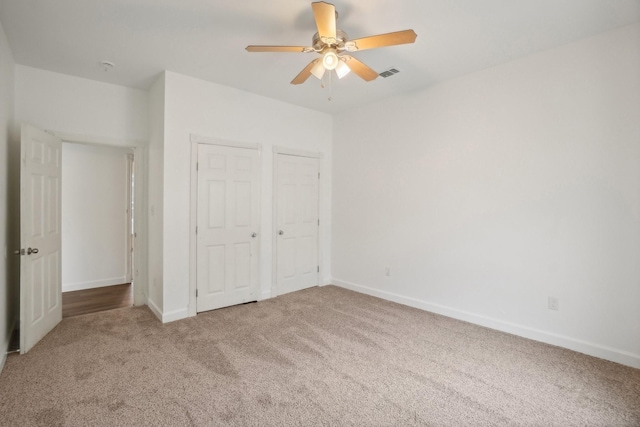 unfurnished bedroom featuring carpet floors and ceiling fan