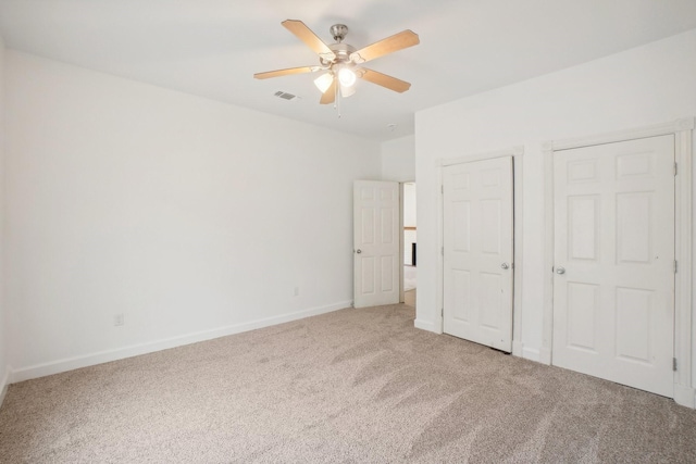 unfurnished bedroom featuring ceiling fan and carpet