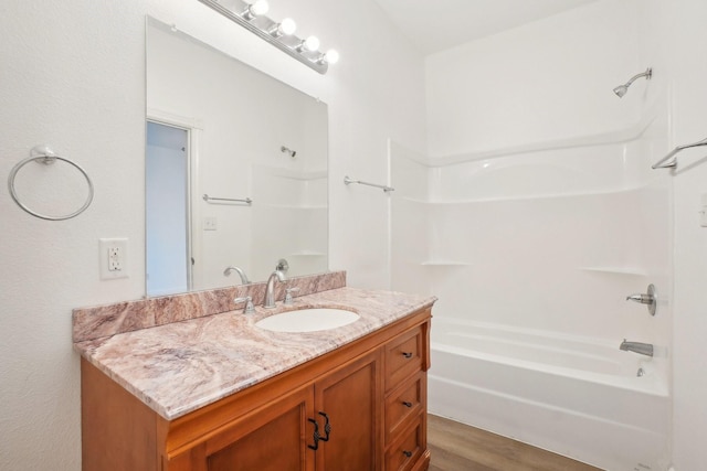 bathroom featuring vanity, shower / washtub combination, and hardwood / wood-style floors