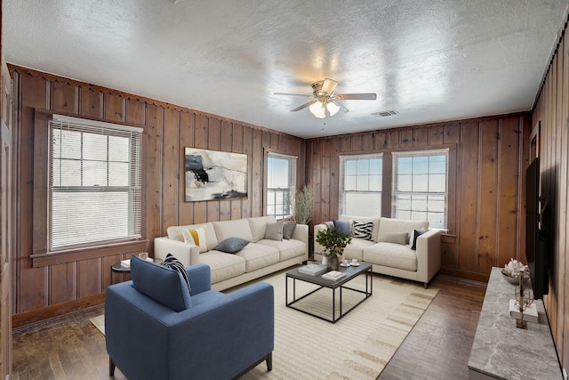 living room featuring hardwood / wood-style flooring, ceiling fan, and plenty of natural light