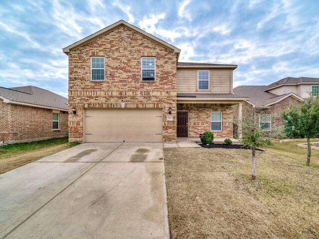 front of property with a front lawn and a garage