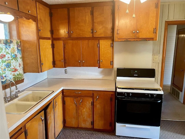 kitchen featuring white range with gas cooktop and sink