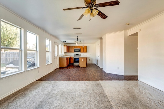 kitchen with stainless steel appliances, ceiling fan, a healthy amount of sunlight, pendant lighting, and a kitchen island