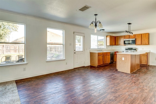 kitchen featuring pendant lighting, a notable chandelier, dishwasher, a center island, and stainless steel electric range