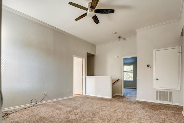 carpeted empty room with ornamental molding and ceiling fan