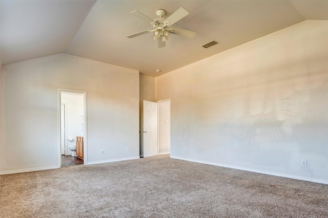 carpeted spare room featuring ceiling fan and vaulted ceiling