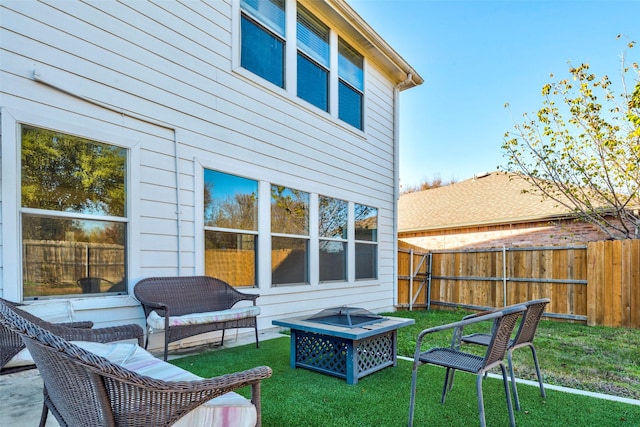 rear view of house featuring an outdoor fire pit