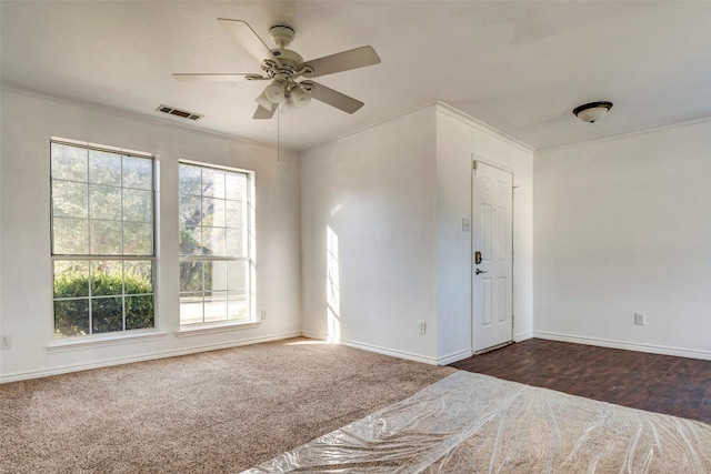 carpeted spare room featuring ceiling fan and ornamental molding