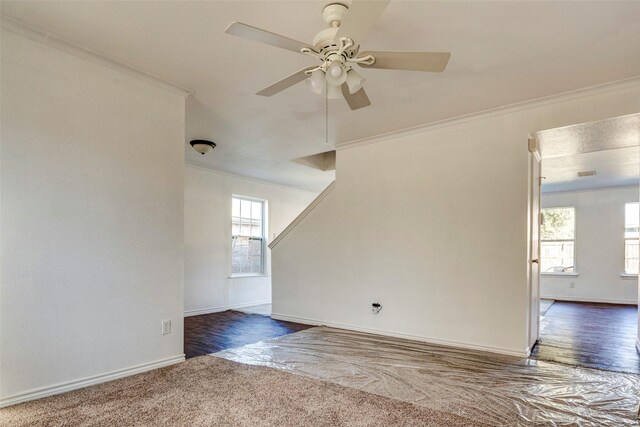 unfurnished room featuring ceiling fan, plenty of natural light, and crown molding