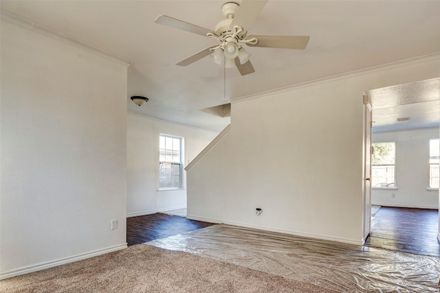 spare room with crown molding, ceiling fan, and dark hardwood / wood-style flooring