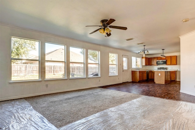 unfurnished living room with crown molding, dark parquet floors, and ceiling fan with notable chandelier