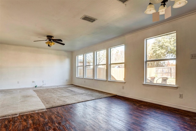 empty room featuring dark hardwood / wood-style flooring, ceiling fan, and crown molding