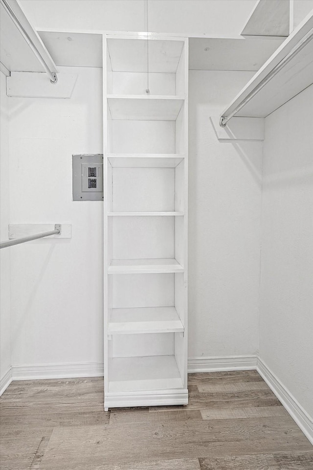 spacious closet featuring wood finished floors and electric panel