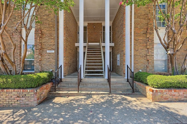 view of exterior entry featuring brick siding