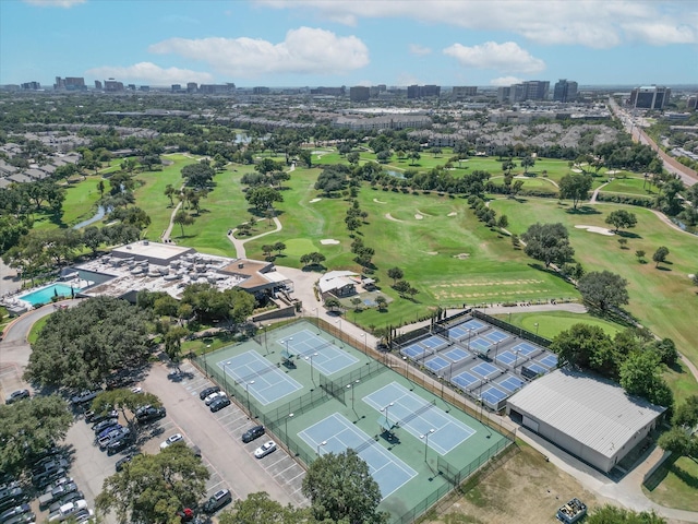 bird's eye view featuring view of golf course and a city view