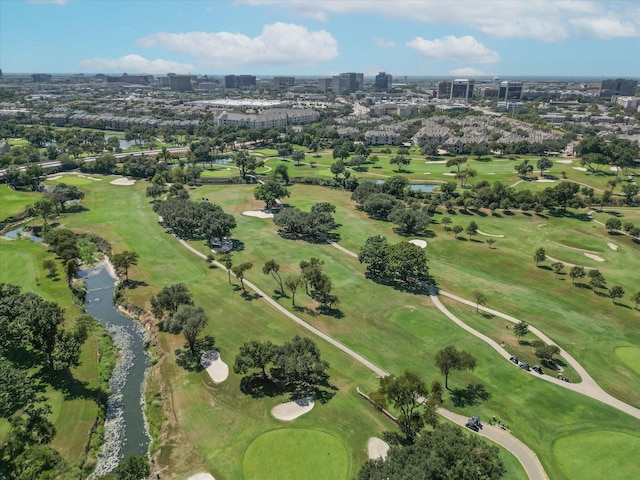 drone / aerial view with golf course view and a city view