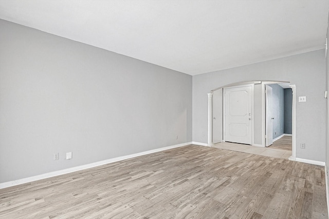 spare room with light wood finished floors and baseboards