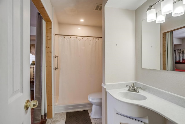 bathroom featuring a shower with curtain, tile patterned floors, vanity, and toilet