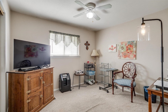 living area with ceiling fan and light carpet