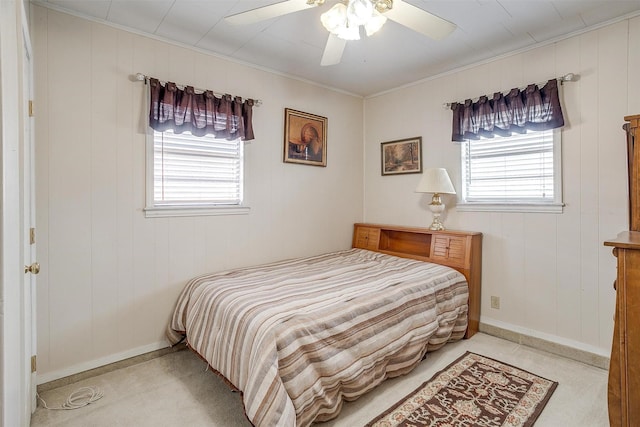 carpeted bedroom with ceiling fan and ornamental molding