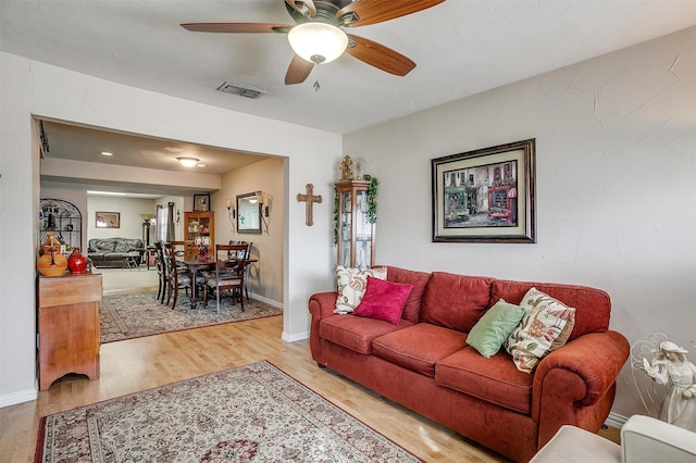 living room with ceiling fan and wood-type flooring