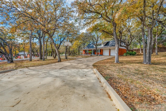 view of front of property with a garage and a front lawn