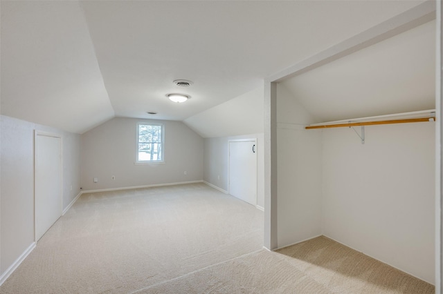 additional living space featuring light carpet and lofted ceiling