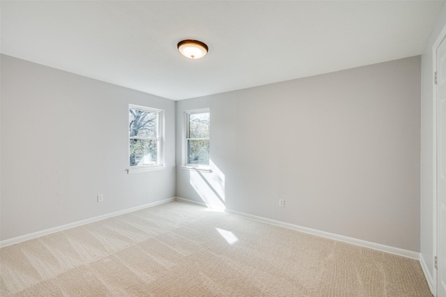 unfurnished room with light carpet