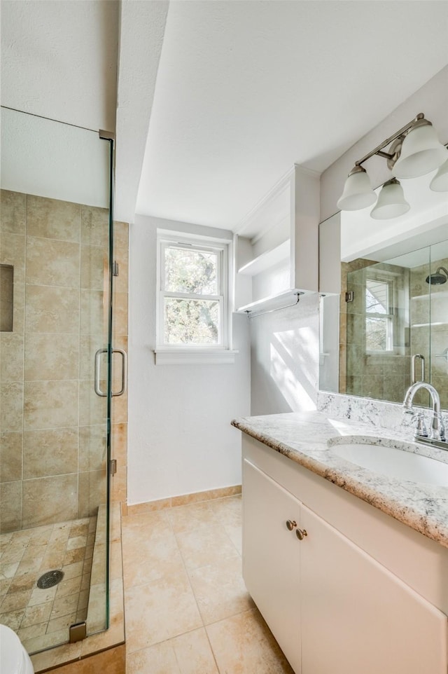 bathroom with vanity, tile patterned floors, and an enclosed shower