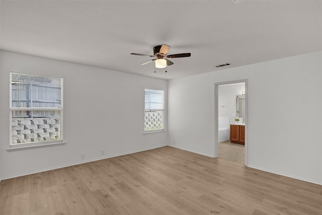 empty room featuring ceiling fan and light hardwood / wood-style flooring