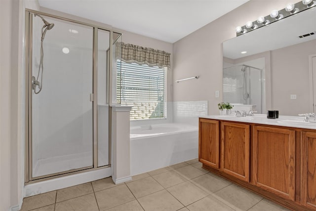 bathroom with tile patterned floors, separate shower and tub, and vanity