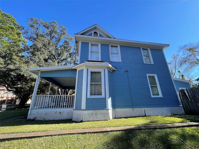 view of property exterior featuring a yard and covered porch