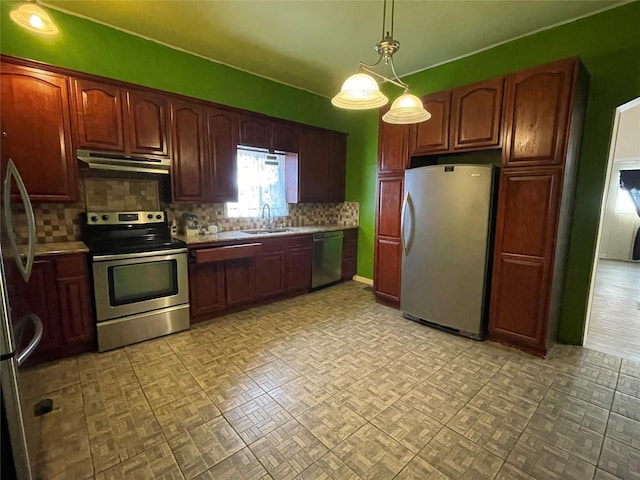 kitchen with appliances with stainless steel finishes, pendant lighting, sink, decorative backsplash, and light parquet floors