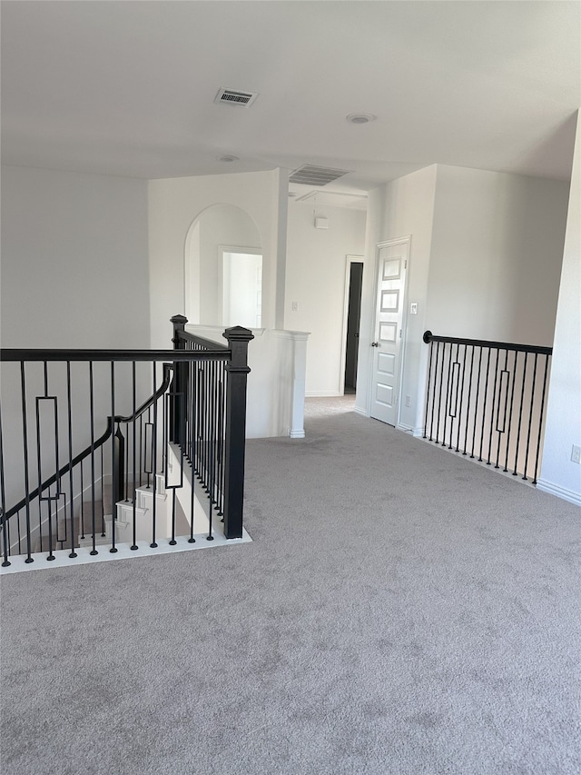 hallway featuring light colored carpet