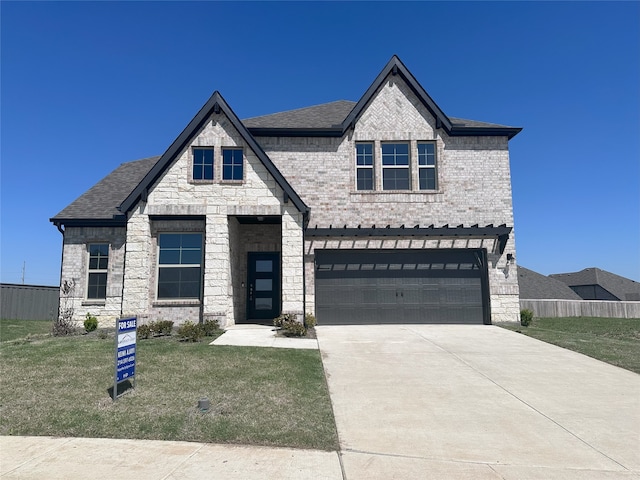 view of front of house with a garage and a front lawn