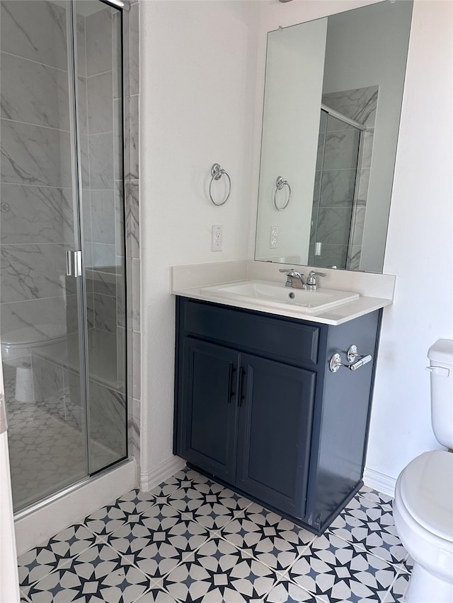 bathroom with vanity, toilet, and a shower with shower door