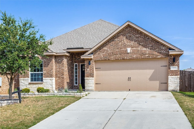 view of front of home with a garage and a front yard