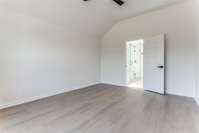 empty room featuring lofted ceiling, light hardwood / wood-style flooring, and ceiling fan